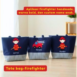 Totebag anak warna dongker tema Pemadam Kebakaran dengan aplikasi kain merah karakter petugas pemadam dan custom nama anak.