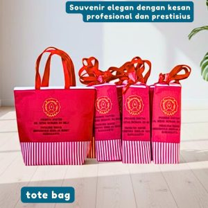 Detail kerapihan jahitan dan bahan polyester waterproof tebal pada totebag merah souvenir promosi doktor UNS.